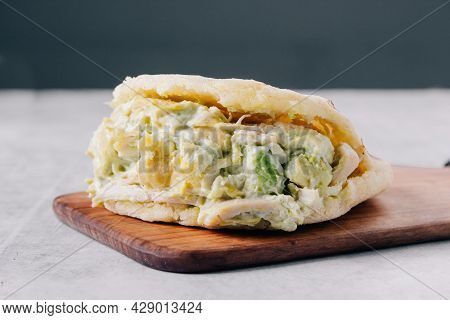 Typical Venezuelan Arepa De Reina Pepeada On A Wooden Board