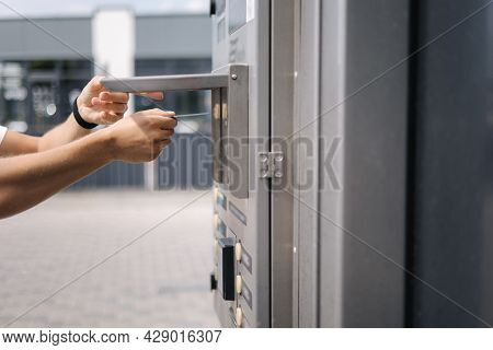 Man Put Plactic Card For Paying Outdoors On Self-service Car Wash