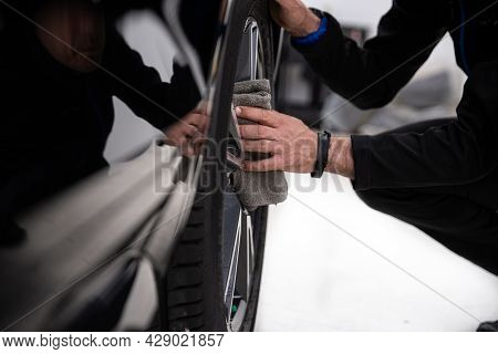 Man Car Detailing Studio Worker Cleaning Car Wheel