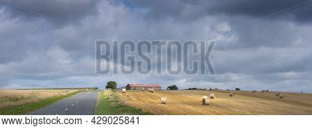Cloudy Sky And Summer Countryside Landscape With Straw Bales And Barn In French Ardennes Near Charle