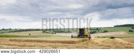 Rural Landscape Of Northern France With Combine During Harvest In French Countryside Landscape Near 