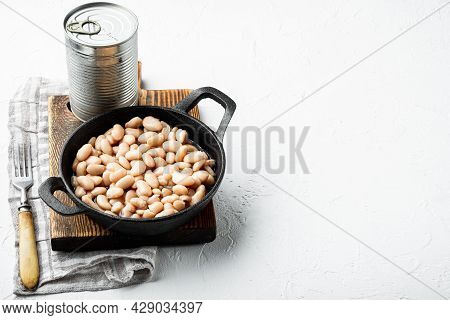 Canned White Beans Set, With Metal Can, In Cast Iron Frying Pan, On White Stone  Surface, With Copy 