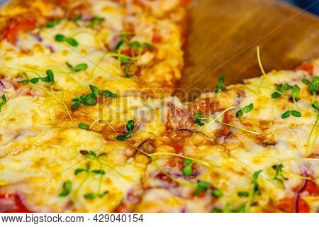 Freshly Prepared Pizza On A Stainless Steel Table In A Cafe Kitchen. Appetizing Hot Pizza With Chees