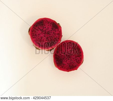 Fresh Dragon Fruit Or Pitaya Cut Into Two Halves Against White Background