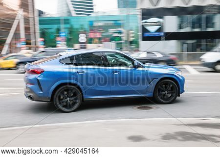 Moscow , Russia - April 2021: Blue Bmw X6 Third Generation G06 Driving In City With Motion Blur, Vie