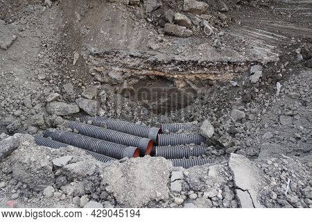 Ongoing Construction Works Going On An Indian Street. Construction Machine Has Dug Up A Trench In A 