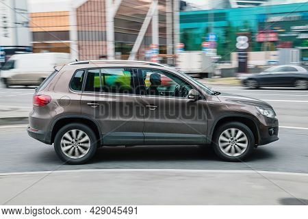 Fast Moving Brown Volkswagen Tiguan Suv Rides On A City Road. A Car On Street In Motion. Overspeed I