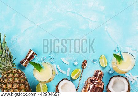 Traditional Pina Colada Cocktail Ingredients And Bar Tools - Shaker, Strainer, Spoon And Glasses Of 