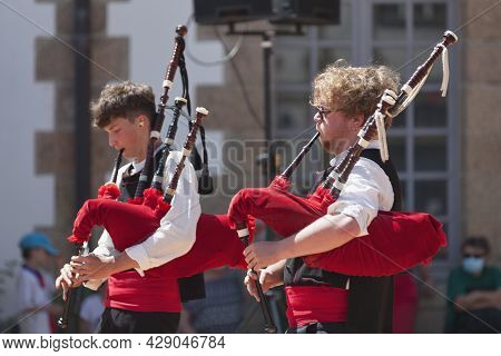 Morlaix, France - July 18 2021: Two Breton Musicians In Traditional Costume Playing Bagpipes.
