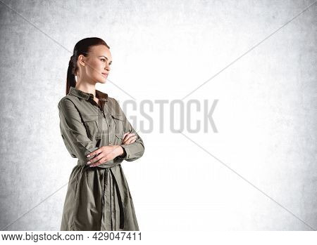 Confident Attractive Woman In Casual Hacky Dress In Crossed Arm Pose Is Pondering About Life And Edu