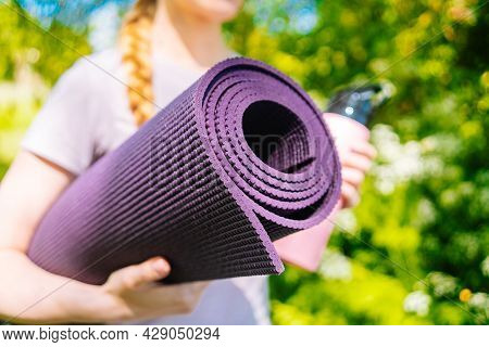 Sportswoman Going To Yoga Practice With Mat Being Ready For Exercising In Gym. Sporty Girl Holding Y