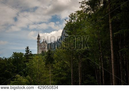 View Of The Neuschwanstein Castle Between The Woods, Bavaria Region, Germany