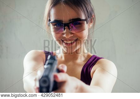 A Woman Target Practicing With A Handgun For Self Defense
