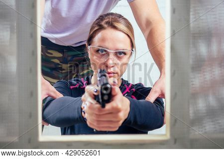 A Woman Target Practicing With A Handgun For Self Defense