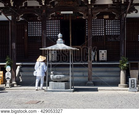 Saijo, Ehime Prefecture, Japan - April 12, 2018: O-henro Buddhist Pilgrim In White Robes At Kichijoj