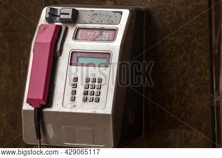 Zagreb, Croatia - July 20, 2021: Pink Croatian Payphone, An Old Public Phone Booth, Damaged, Obsolet