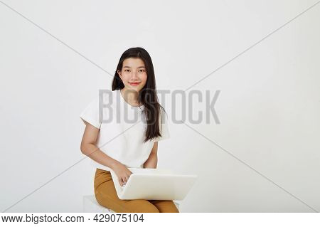 Woman With Laptop Computer Sitting Cross Legged And Looking