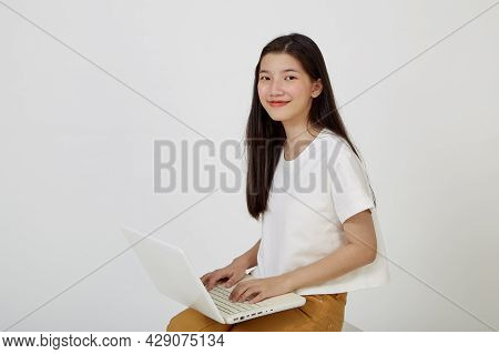 Woman With Laptop Computer Sitting Cross Legged And Looking