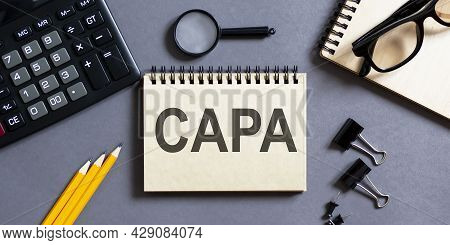 Notepad With Inscriptions Capa On A Grey Background With Office Tools . Business