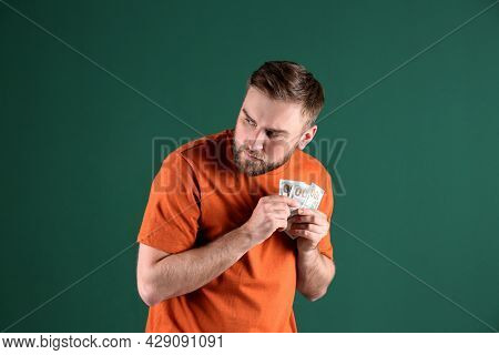 Greedy Young Man Hiding Money On Green Background