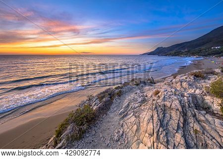 Walking Trail Through Coastal Vegetation On The Rocky Coastline Of Cap Corse, Corsica, France
