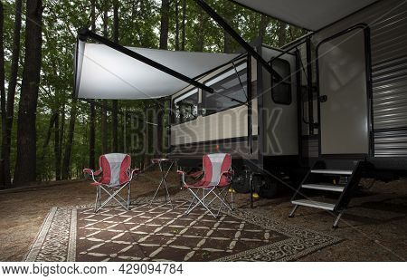Empty Chairs Under The Awning Of A Travel Trailer At Jordan Lake