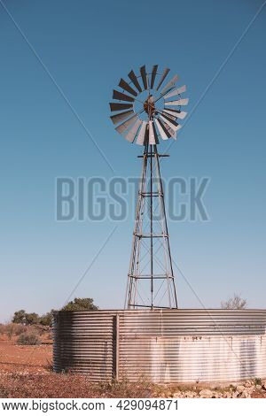 Vintage Water Windpump Against Clear Blue Sky In Namibian Desert