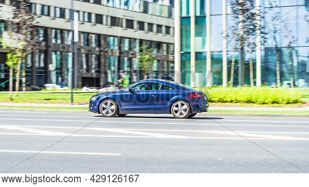 Blue Audi Tt Mk2 Is Driving On High Speed In Front Of Modern Buildings With Glass Facade. Moscow, Ru
