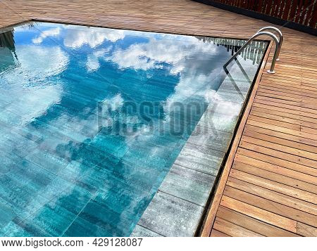 Rimless Pool, With The Exterior Surrounded By Teak Wood, Deep Blue Crystal Clear Water, Swimming Poo