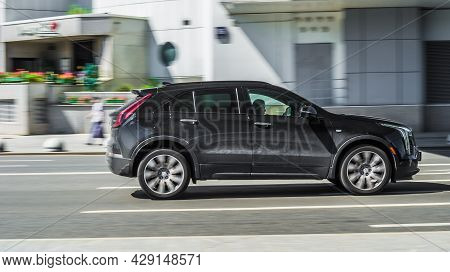 Cadillac Xt4 Black Color Moving On The Street. Modern Suv Fast Speed Drive On City Road. Moscow, Rus