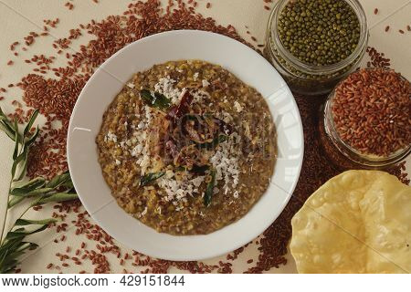 Porridge Or Gruel Made Of Navara Rice, Mung Beans And Fenugreek Seeds Sprinkled With Fresh Grated Co