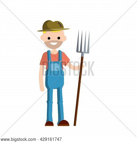 Man Farmer In Overalls With Fork In Hands. Rural Type Of Work.