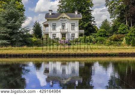 Tynaarlo, Netherlands - August 04, 2021: Historic White Mansion At The Noord-willems Canal In Drenth