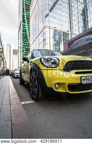Yellow Mini Countryman Parked Along The Street On Urban Background. Mini Crossover First Generation 