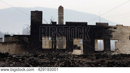 Fire Debris Of Houses In A Small Town With Smoke In Sky. Caused By Forest Wildfires In Lytton, Briti