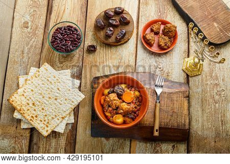 Jewish Dish Shut With Meat On A Wooden Table Near Matzo And Ingredients. Horizontal Photo