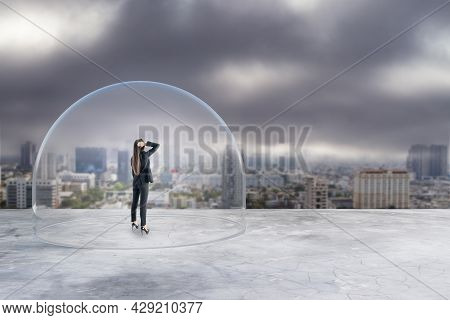 Businesswoman Under Glass Cover Standing On Gloomy City Background With Mock Up Place. Work Prison C