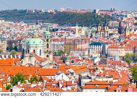 Baroque Cupola Of Saint Nicholas Church In Lesser Town And Old Town Towers On Background, Czech Repu
