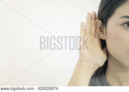 Listening Concept. The Woman Shook Her Hand Near The Ear And Listened Carefully, Separately On A Whi