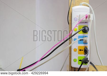 Cable Connector For Overloaded Power Boards Close Up Focus At A Plug Foreground. Multiple Socket Wit