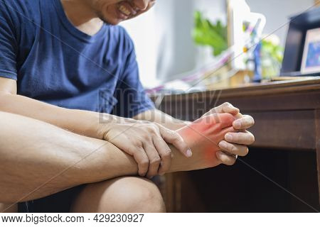 Man With Painful And Inflamed Gout On His Foot Around The Big Toe Area.