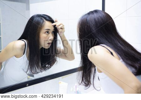 Asian Women Are Exploring Their Faces Due To Acne. Looks In The Mirror And Crushes Pimple. Problem S