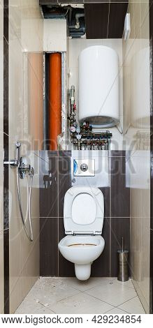 Restroom Repair. Restroom With Removed Tiles Due To Need To Replace The Riser And Pipes. Complex Pip