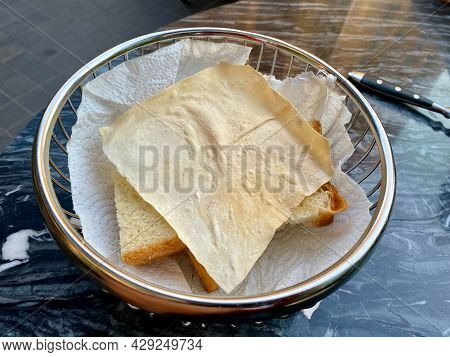 Papadum Flatbread Crackers Served At Restaurant As Appetizer. Ready To Serve In Metal Basket.