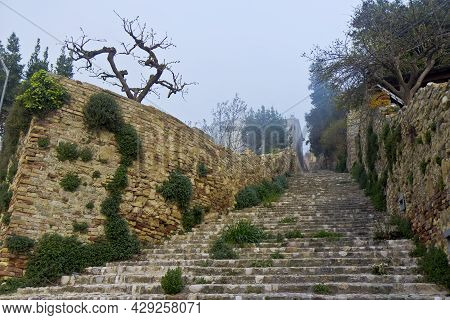 Ancient Stone Steps From The City Of Ripatransone, Ascoli Piceno, Italy. Old Stone Steps And Brick W
