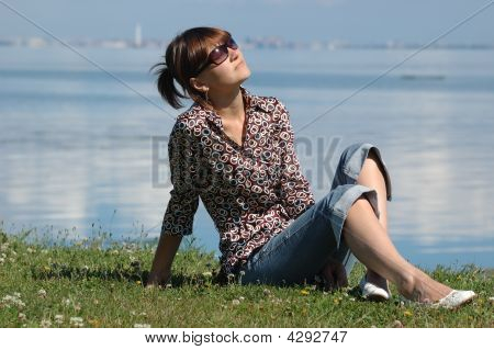 Sunbathing Girl On The Grass