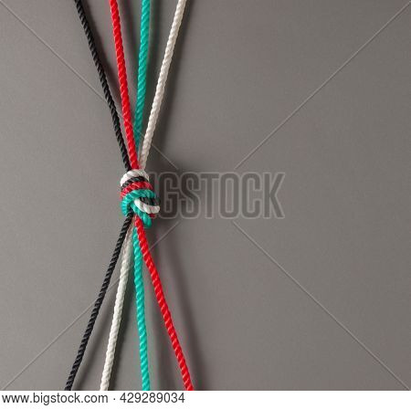 Conceptual photo for 'unity' of Emirati citizens. UAE flag color ropes tied together to connote 'strength' and 'togetherness'. 