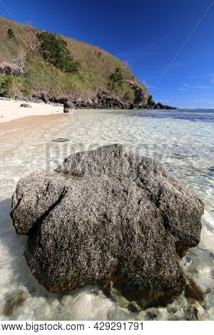 A Rocky Beach With Clear Tropical Water