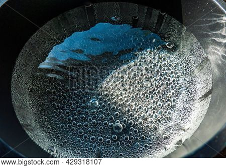 Clear Water At The Very Beginning Of The Boiling Process. A Lot Of Steam Bubbles Have Formed At The 