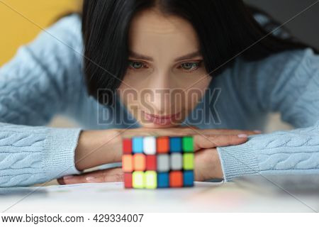 Tired Sad Woman Looks At Uncollected Rubik Cube